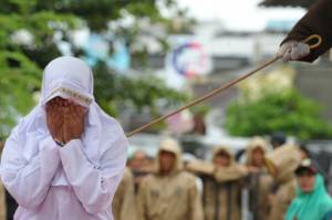 Woman screams in pain during caning in Indonesia's Aceh.jpg