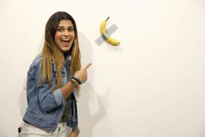 Man eats $120,000 piece of art -- a banana taped to wall.jpg Man eats $120,000 piece of art -- a banana taped to wall.jpg