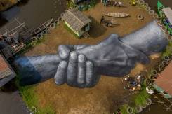 Giant fresco appears in floating Benin village.jpg