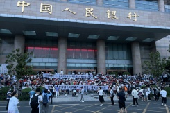 China arrests hundreds over banking scandal that sparked rare protests