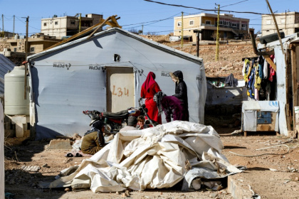 Syrian refugees stand outside a tent about to be dismantled at a camp in Arsal, eastern Lebanon, before returning to Syria Syrian refugees stand outside a tent about to be dismantled at a camp in Arsal, eastern Lebanon, before returning to Syria