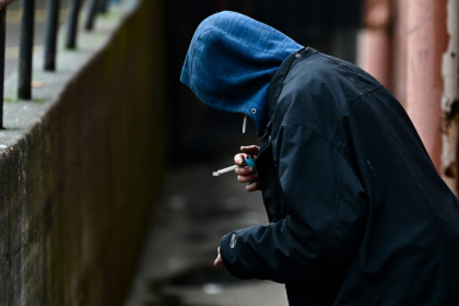 A person holds a lighter in an alleyway while smoking in the US state of Oregan in 2024 A person holds a lighter in an alleyway while smoking in the US state of Oregan in 2024