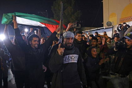 People celebrated while watching a television on a street in Khan Yunis, southern Gaza, as news of the ceasefire spread People celebrated while watching a television on a street in Khan Yunis, southern Gaza, as news of the ceasefire spread