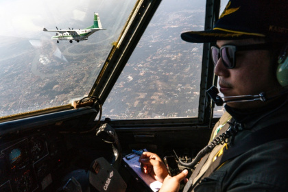 A pilot flies next to another aircraft from Thailand's Royal Rainmaking department spraying icy water in the air outside Bangkok in a bid to reduce pollution A pilot flies next to another aircraft from Thailand's Royal Rainmaking department spraying icy water in the air outside Bangkok in a bid to reduce pollution
