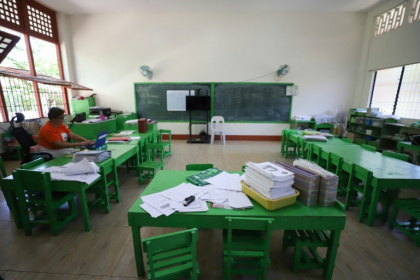 A teacher works inside an empty classroom after in-person classes were suspended due to dangerous heat in Iloilo City, central Philippines on April 2, 2024 A teacher works inside an empty classroom after in-person classes were suspended due to dangerous heat in Iloilo City, central Philippines on April 2, 2024