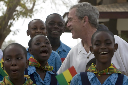 US President George W. Bush listens to schoolchildren sing as he visits a project backed by USAID in Accra, Ghana in 2008 US President George W. Bush listens to schoolchildren sing as he visits a project backed by USAID in Accra, Ghana in 2008