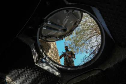 Mountain lair: a soldier looks into a hidden exit from from Maher al-Assad's private office built into a hilltop overlooking Damascus Mountain lair: a soldier looks into a hidden exit from from Maher al-Assad's private office built into a hilltop overlooking Damascus