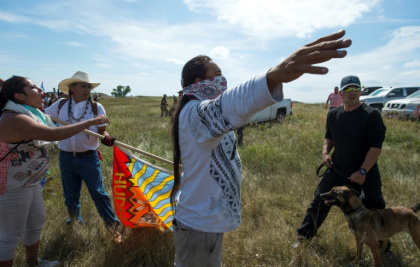 A Native American protestors holds up his arms as he and other protestors are threatened by private security guards and guard dogs, at a work site for the Dakota Access Pipeline (DAPL) oil pipeline, near Cannon Ball, North Dakota, September 3, 2016 A Native American protestors holds up his arms as he and other protestors are threatened by private security guards and guard dogs, at a work site for the Dakota Access Pipeline (DAPL) oil pipeline, near Cannon Ball, North Dakota, September 3, 2016