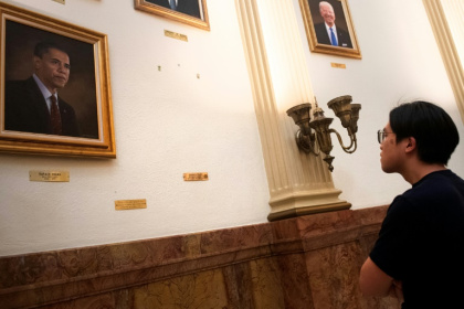 A tourist looks at the empty space where a portrait of US President Donald Trump once hung in the Presidential Portrait Gallery at the Colorado Capitol in Denver A tourist looks at the empty space where a portrait of US President Donald Trump once hung in the Presidential Portrait Gallery at the Colorado Capitol in Denver