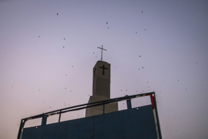 Bats fly over a church tower in Jos, capital of the religiously mixed Plateau state, Nigeria Bats fly over a church tower in Jos, capital of the religiously mixed Plateau state, Nigeria