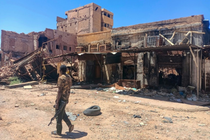 A fighter loyal to Sudan's army patrols a market area in the capital Khartoum A fighter loyal to Sudan's army patrols a market area in the capital Khartoum