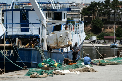 Workers handle a fishing net near a trawler docked at the port of Nea Michaniona, in northern Greece - Sakis Mitrolidis (AFP) Workers handle a fishing net near a trawler docked at the port of Nea Michaniona, in northern Greece - Sakis Mitrolidis (AFP)