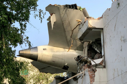 The tailpiece of the crashed Air India Dreamliner juts from a building in Ahmedabad - Sam PANTHAKY (AFP) The tailpiece of the crashed Air India Dreamliner juts from a building in Ahmedabad - Sam PANTHAKY (AFP)