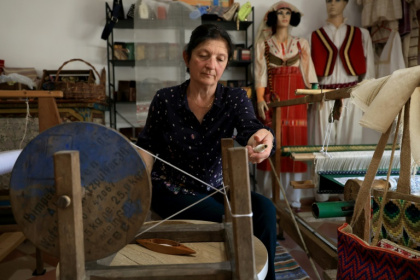 Mimoza Pjetraj works her spinning wheel - Adnan Beci (AFP) Mimoza Pjetraj works her spinning wheel - Adnan Beci (AFP)