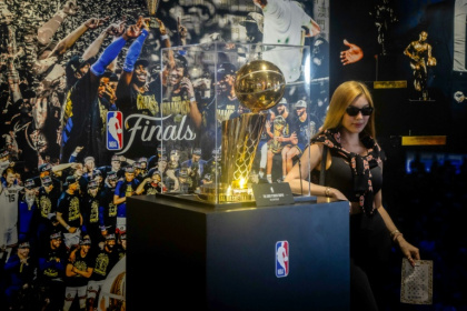 A tourist poses next to the NBA Championship trophy at the Venetian's NBA House in Macau - Eduardo Leal (AFP) A tourist poses next to the NBA Championship trophy at the Venetian's NBA House in Macau - Eduardo Leal (AFP)