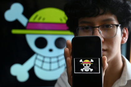 Peruvian student Wildar Lozano, 20, of the Gen Z movement, shows the "One Piece" manga flag - Raul ARBOLEDA (AFP) Peruvian student Wildar Lozano, 20, of the Gen Z movement, shows the "One Piece" manga flag - Raul ARBOLEDA (AFP)