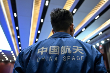 A staff member attends a press conference of the Shenzhou-21 Manned Space Mission one day before the mission's launch - Hector RETAMAL (AFP)