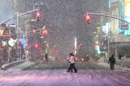 People walk across Times Square during the snowstorm - CHARLY TRIBALLEAU (AFP)