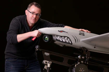 Ukrspecsystems Managing Director Rory Chamberlain poses for a photograph with one of the company's Shark reconnaissance drones at their UK factory near Cambridge, eastern England - Chris Radburn (AFP)