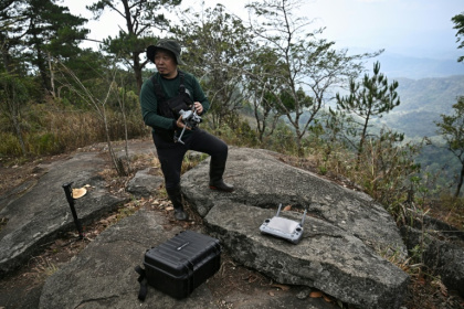 Hmong volunteer firefighter Mongkol Yingyotmongkolsaen using a drone to monitor fires in the Doi Suthep-Pui National Park area of Chiang Mai - Lillian SUWANRUMPHA (AFP)