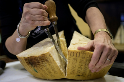Ranked among the kings of Italian cheese, with its cows fed on hay and grass, Parmesan is facing slowing sales at home as the country's population declines - MARCO BERTORELLO (AFP)