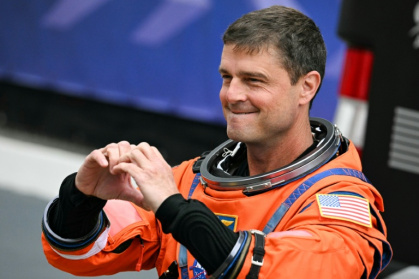 NASA astronaut Reid Wiseman gestured a heart sign before the Artemis II took off to orbit the Moon, where astronauts proposed for a crater to be named "Carroll" in honor of his deceased wife - Jim WATSON (AFP)
