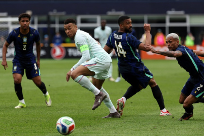 Kylian Mbappe, in white, in action for France against Brazil in March -- these two nations are among the leading contenders to win the upcoming World Cup - FRANCK FIFE (AFP)
