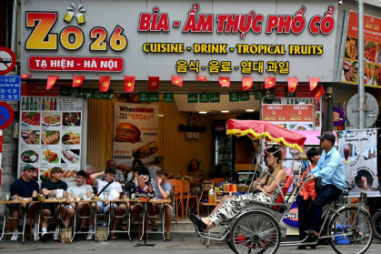 Hanoi's wide boulevards and narrow lanes have long been clogged with food stalls, scooters, and crowds drinking coffee and beer - Nhac NGUYEN (AFP)