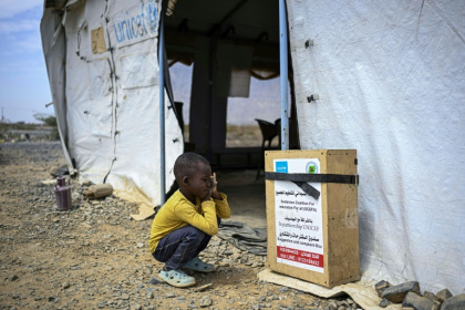 A displaced Sudanese student sitting outside a tent serving as a temporary classroom. The Middle East war is hitting UNICEF's supply chains - Khaled DESOUKI (AFP)