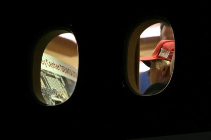 This AFP photo by Brendan Smialowski shows US President Donald Trump aboard Air Force One looking at a placard appearing to depict the razing of Washington's Kennedy Center arts venue - Brendan SMIALOWSKI (AFP)