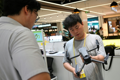 At buy-back sites sites across the Chinese capital, queues of people waited for staff to appraise their drones - Pedro PARDO (AFP)