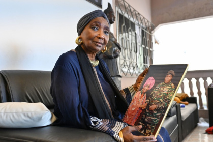 Ivorian diva Aicha Kone, shown holding a photo of herself with Niger's leader General Abdourahamane Tiani, is a Sahel junta supporter - Sebastien RIEUSSEC (AFP)